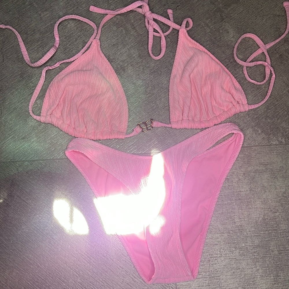 Baby pink two-piece bathing suit with butterfly gem in the middle